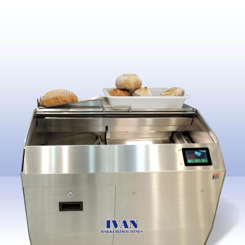 Vooraanzicht op de broodsnijmachine Jac VARIA SELF 2, met gesneden en ongesneden brood erop+